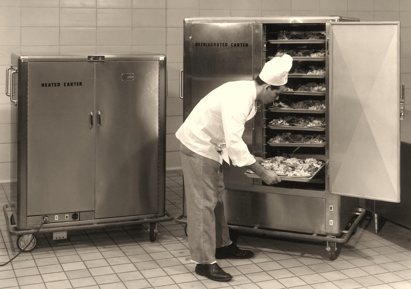 Chef bending over to take bread out of a commercial oven
